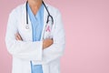 Doctor woman with breast cancer awareness ribbon Royalty Free Stock Photo