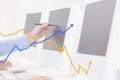 Hand using computer with graph overlays Royalty Free Stock Photo
