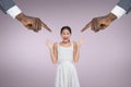 Hands pointing at surprised business woman against pink background Royalty Free Stock Photo