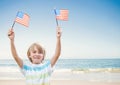 Happy boy holding USA flags in the beach Royalty Free Stock Photo