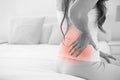 Digital composite of highlighted spine of woman with back pain Royalty Free Stock Photo