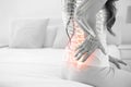 Digital composite of highlighted spine of woman with back pain Royalty Free Stock Photo