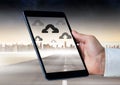 Holding tablet and Cloud icons over city Royalty Free Stock Photo