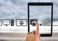 Holding tablet and Computer icons over city Royalty Free Stock Photo