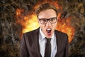 Digital composite image of angry businessman with fire in background Royalty Free Stock Photo