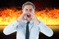 Digital composite image of angry businessman screaming against fire Royalty Free Stock Photo