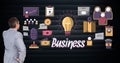 Digital composite image of businessman looking at electric bulb amidst various icons Royalty Free Stock Photo