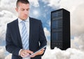 Digital composite image of businessman using digital tablet against server tower Royalty Free Stock Photo