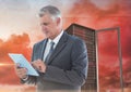 Digital composite image of businessman using digital tablet against server tower Royalty Free Stock Photo