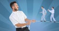 Digital composite image of businessmen walking on rope held by manager Royalty Free Stock Photo