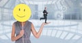 Digital composite image of businesswoman holding smiley while businessman running on her hand Royalty Free Stock Photo