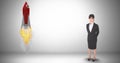 Digital composite image of businesswoman standing by rocket launch against gray background Royalty Free Stock Photo