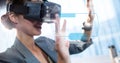 Digital composite image of businesswoman touching futuristic screen while using VR glasses Royalty Free Stock Photo