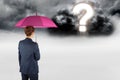 Digital composite image of businesswoman with umbrella looking at question mark in sky Royalty Free Stock Photo