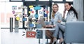 Digital composite image of businesswomen with technologies sitting by new idea icons