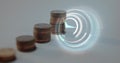 Digital composite image of digital clock ticking against multiple stack of coins
