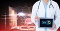 Digital composite image of doctor showing digital tablet against medical background Royalty Free Stock Photo