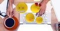 Digital composite image of emojis flying over hands using laptop at table Royalty Free Stock Photo