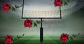 Digital composite image of falling red roses against goal post on american football field