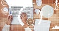 Digital composite image of hands using laptop by crumpled pappers