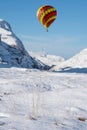 Digital composite image of hot air balloons flying over Beautiful iconic landscape Winter image of Stob Dearg Buachaille Etive Mor