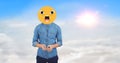 Digital composite image of man using phone face covered with emoji against sky Royalty Free Stock Photo