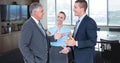 Digital composite image of manager explaining while discussing with colleagues in office Royalty Free Stock Photo