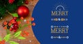 Digital composite image of merry christmas text by decorative cherries and baubles on table Royalty Free Stock Photo