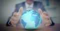 Digital composite image of mid section of businessman holding globe