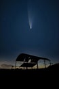 Digital composite image of Neowise Comet over Derelict barn silhouette against beautiful vibrant sunset landscape Royalty Free Stock Photo