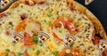 Digital composite image of pizza icons over cheesy pizza served in plate