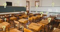 Digital composite image of question marks over school classroom with empty wooden desks and benches Royalty Free Stock Photo