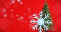 Digital composite image of snowflakes and christmas tree against red background with copy space Royalty Free Stock Photo