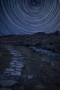 Digital composite image of star trails around Polaris with Beautiful Winter landscape image looking along valley from Crimpiau