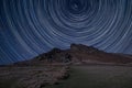 Digital composite image of star trails around Polaris with Epic Peak District Winter landscape of Ramsaw Rocks viewed from Hen