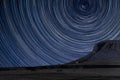 Digital composite image of star trails around Polaris with landscape of Norber Ridge in Yorkshire Dales National Park Royalty Free Stock Photo