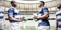 Digital composite image of team of rugby players facing each other while holding rugby ball in sport Royalty Free Stock Photo