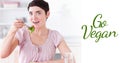 Digital composite image of woman portrait eating salad by go vegan text symbol