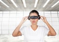 Digital composite image of woman using virtual reality glasses Royalty Free Stock Photo