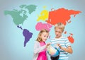 Kids turning world globe in front of colorful world map