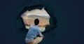 Man looking through surreal paper hole at nature landscape Royalty Free Stock Photo