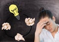 Man next to light bulb with crumpled paper balls in front of blackboard Royalty Free Stock Photo