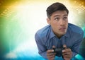man playing with computer game controller with bright colorful background Royalty Free Stock Photo