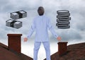 Money icons and Businessman standing on Roofs with chimney and cloudy sky Royalty Free Stock Photo