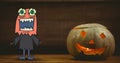 Monster cartoon standing next to halloween pumpkin Royalty Free Stock Photo