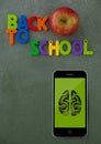 Phone on a school table with brain icon on screen Royalty Free Stock Photo