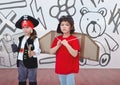 Pirate girl and pilot boy in room with kids drawing graphics Royalty Free Stock Photo