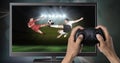 Playing soccer computer game with controller in hands Royalty Free Stock Photo