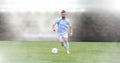 Soccer player on grass with stadium Royalty Free Stock Photo