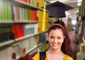 Student woman in education library with graduation hat